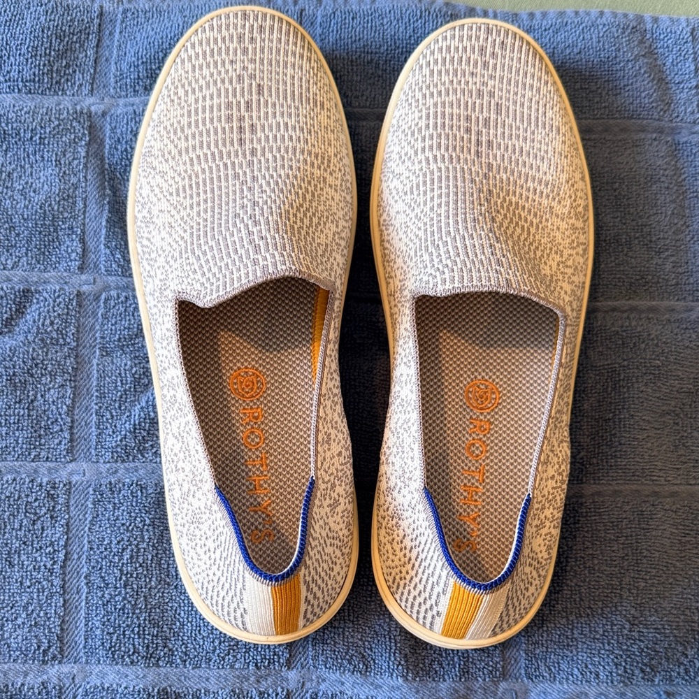 Rothy's Women’s snakeskin design canvas slip-on sneakers in cream and gray.